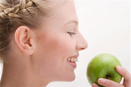 Woman holding green apple Stock Photo - Premium Royalty-Free, Code: 659-03531982