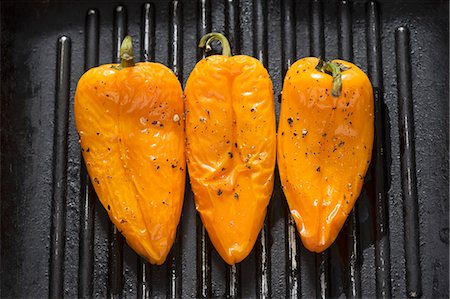 Three yellow peppers in a grill frying pan Stock Photo - Premium Royalty-Free, Code: 659-03532001