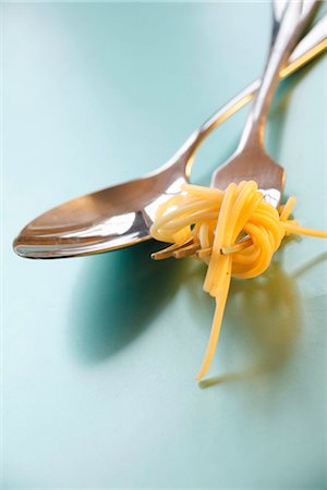 fork with noodles - Spoon and fork with spaghetti Stock Photo - Premium Royalty-Free, Code: 659-03532147