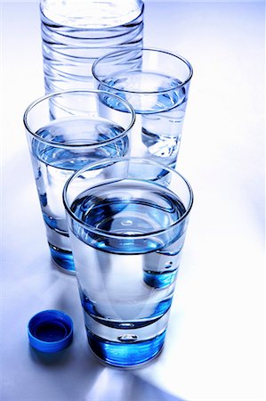 drinking water glass - Three glasses of mineral water with bottle Stock Photo - Premium Royalty-Free, Code: 659-03533169