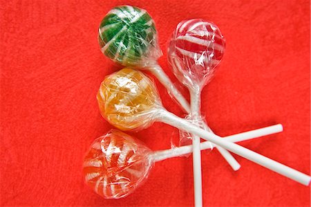 Four coloured lollipops in cellophane paper Stock Photo - Premium Royalty-Free, Code: 659-03533826