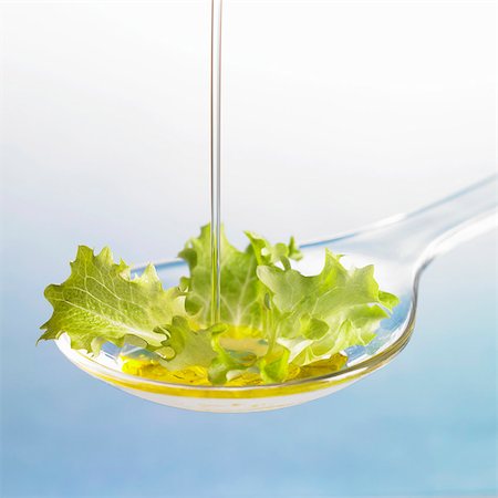 flowing - Oil running onto lettuce leaf on spoon Stock Photo - Premium Royalty-Free, Code: 659-03533885