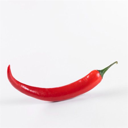 pepper (vegetable) - A red chilli against a white background Stock Photo - Premium Royalty-Free, Code: 659-03533980