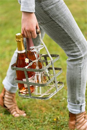 simsearch:825-05985931,k - Person holding a metal bottle carrier with glasses and bottles of Champagne Stock Photo - Premium Royalty-Free, Code: 652-05807172