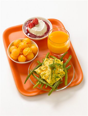 summer meal - T.V dinner tray with melon,omelette with green beans,yoghurt with raspberry puree Stock Photo - Premium Royalty-Free, Code: 652-05809328