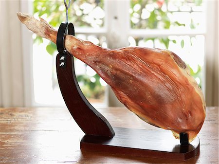 pedestal - Serrano ham on a carving stand Stock Photo - Premium Royalty-Free, Code: 652-07655400