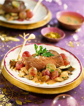 Ostrich steak with pan-fried ceps and grapes Stock Photo - Premium Royalty-Free, Code: 652-03635718