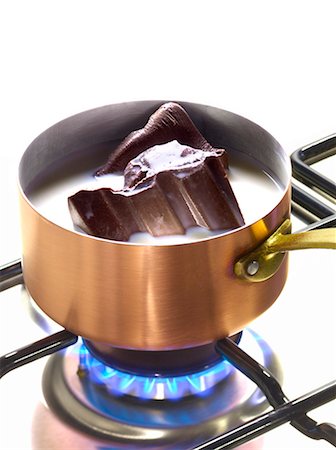 Melting pieces of chocolate in milk in a copper saucepan Stock Photo - Premium Royalty-Free, Code: 652-03802250