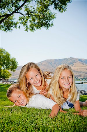 Three young children playing in lakeside park Stock Photo - Premium Royalty-Free, Code: 673-06025465