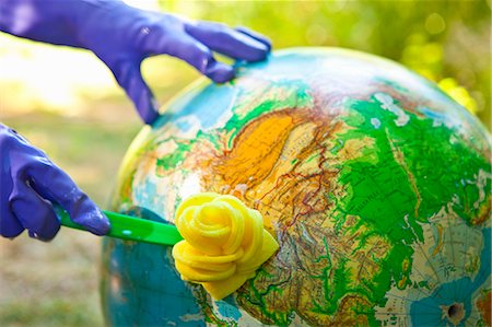 dirty environment - Woman wearing rubber gloves to scrub globe outdoors Stock Photo - Premium Royalty-Free, Code: 673-06025570