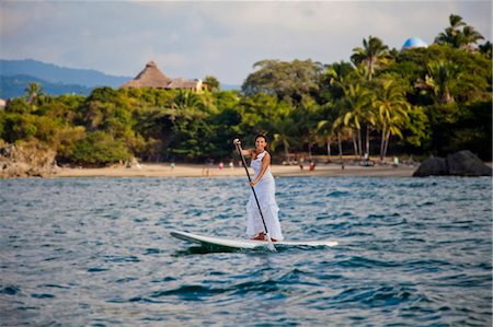 simsearch:673-06964643,k - Woman in white dress riding paddle board Stock Photo - Premium Royalty-Free, Code: 673-06964469
