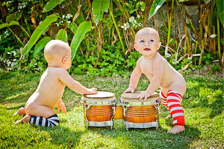 percussion instrument - Twin babies playing drums outdoors Stock Photo - Premium Royalty-Free, Code: 673-06964584
