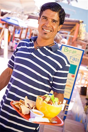 signs for mexicans - Man holding plate of mexican food Photographie de stock - Premium Libres de Droits, Code: 673-06964625