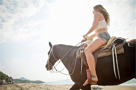 Young woman riding horse on beach Stock Photo - Premium Royalty-Free, Code: 673-06964672