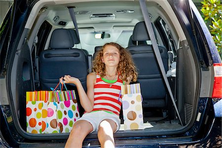 Teen girl with shopping bags in car Stock Photo - Premium Royalty-Free, Code: 673-06964688