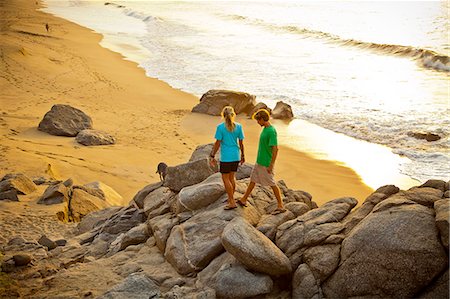 dog walking - Couple with dog hiking on beach rocks Stock Photo - Premium Royalty-Free, Code: 673-06964787