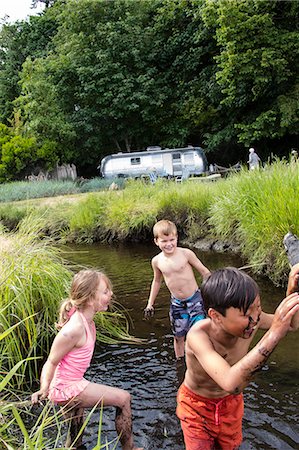 preteen girl topless - Children playing in a muddy creek Stock Photo - Premium Royalty-Free, Code: 673-08139202