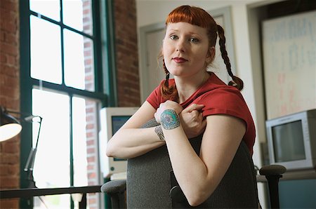 Portrait of a red-haired woman in her office. Stock Photo - Premium Royalty-Free, Code: 673-02137563