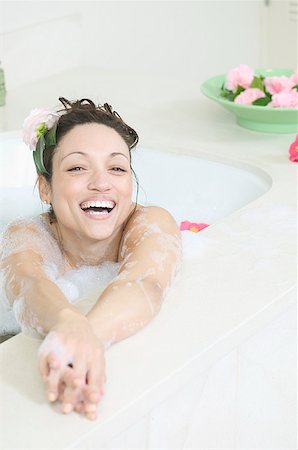 A woman smiling as she relaxes in a bathtub full of bubbles. Stock Photo - Premium Royalty-Free, Code: 673-02137669