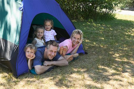 simsearch:673-02138237,k - Caucasian family looking out of tent at campsite. Stock Photo - Premium Royalty-Free, Code: 673-02137809