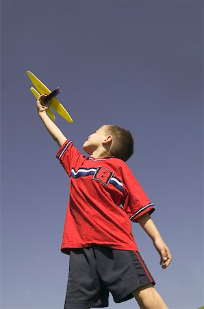 Young boy flying a model airplane. Stock Photo - Premium Royalty-Free, Code: 673-02137960