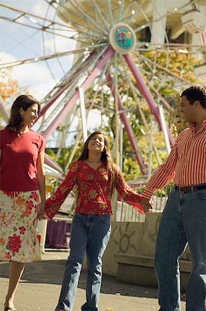 simsearch:673-02138237,k - Parents and daughter at an amusement park. Stock Photo - Premium Royalty-Free, Code: 673-02138043