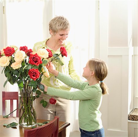 Mother arranging roses with her daughter. Stock Photo - Premium Royalty-Free, Code: 673-02138061