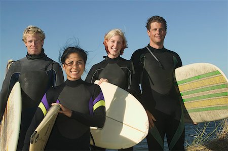 surfboard close up - Portrait of four surfers in wetsuits. Stock Photo - Premium Royalty-Free, Code: 673-02138087