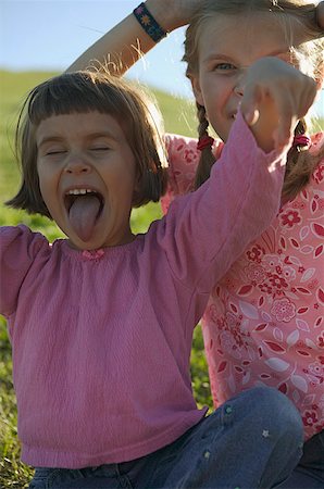 Two young girls making faces. Stock Photo - Premium Royalty-Free, Code: 673-02138111