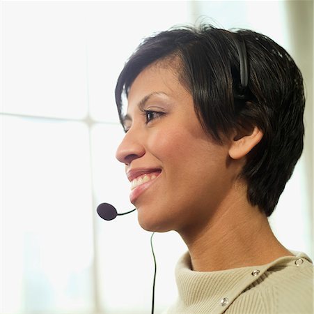 Woman wearing a telephone headset. Stock Photo - Premium Royalty-Free, Code: 673-02138377