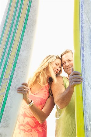 surfboard close up - A couple standing between surfboards. Stock Photo - Premium Royalty-Free, Code: 673-02138422