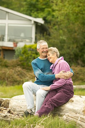 elder care - Senior couple sitting together on a log at the beach. Stock Photo - Premium Royalty-Free, Code: 673-02138423