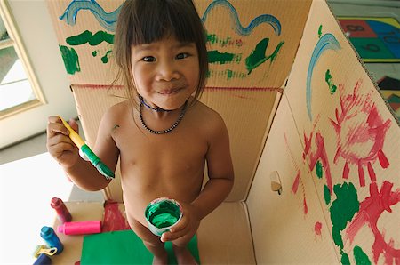 Girl painting a cardboard box. Stock Photo - Premium Royalty-Free, Code: 673-02138549