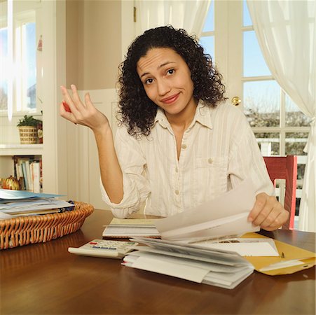 subtracting - Exasperated woman working on a stack of bills. Stock Photo - Premium Royalty-Free, Code: 673-02138614