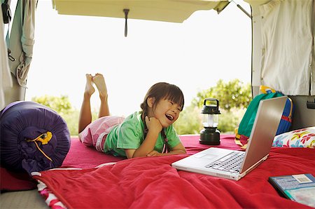 Girl using her laptop while car- camping Stock Photo - Premium Royalty-Free, Code: 673-02138716