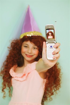 Young girl using a mobile phone with camera Stock Photo - Premium Royalty-Free, Code: 673-02138717