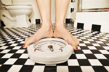 feet scale woman - Woman weighing herself on a bathroom scale Stock Photo - Premium Royalty-Free, Code: 673-02138767