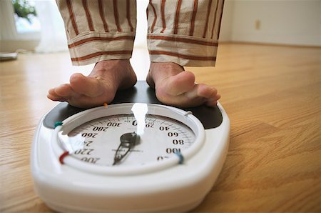 feet on a scale - Man weighing himself on a bathroom scale Stock Photo - Premium Royalty-Free, Code: 673-02138784