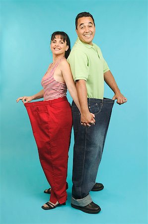 A happy couple showing off their weight loss Stock Photo - Premium Royalty-Free, Code: 673-02138801
