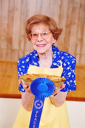 Woman holding her award winning pie Stock Photo - Premium Royalty-Free, Code: 673-02139089