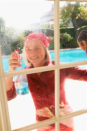 Woman cleaning windows Stock Photo - Premium Royalty-Free, Code: 673-02139118