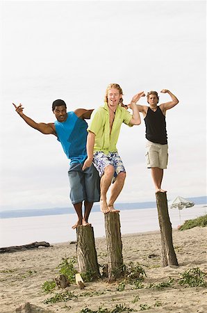 simsearch:673-02139140,k - Men flexing their muscles at the beach Stock Photo - Premium Royalty-Free, Code: 673-02139135
