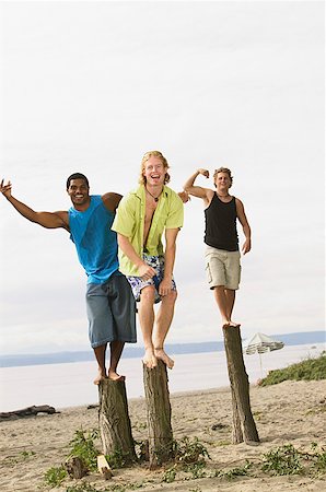 simsearch:673-02139140,k - Men flexing their muscles at the beach Stock Photo - Premium Royalty-Free, Code: 673-02139136