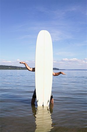 simsearch:673-02139140,k - Man standing behind a surfboard Stock Photo - Premium Royalty-Free, Code: 673-02139130