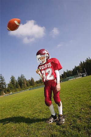 Football player about to get hit with ball Stock Photo - Premium Royalty-Free, Code: 673-02139179