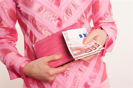 Woman holding euro banknotes Stock Photo - Premium Royalty-Free, Code: 673-02139361