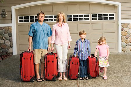 family suitcases - Family standing together with luggage Stock Photo - Premium Royalty-Free, Code: 673-02139377