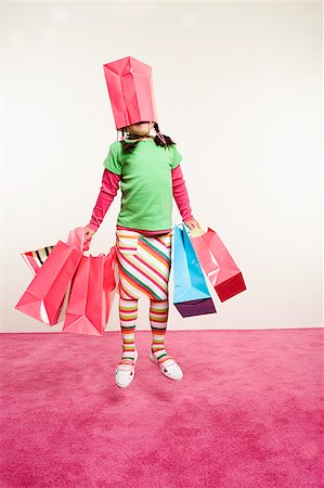 enigma - Jumping girl with shopping bags Stock Photo - Premium Royalty-Free, Code: 673-02139470