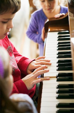 Young boy practicing piano Stock Photo - Premium Royalty-Free, Code: 673-02139524