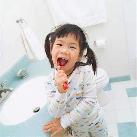 Girl wearing pajamas brushing teeth Stock Photo - Premium Royalty-Free, Code: 673-02139558